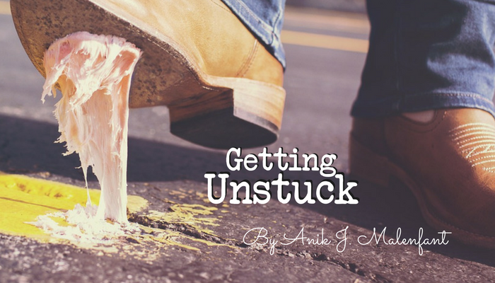 Getting Unstuck - title text and credit to Anik J. Malenfant along with an image of a man's boot that is stuck to the road with chewing gum