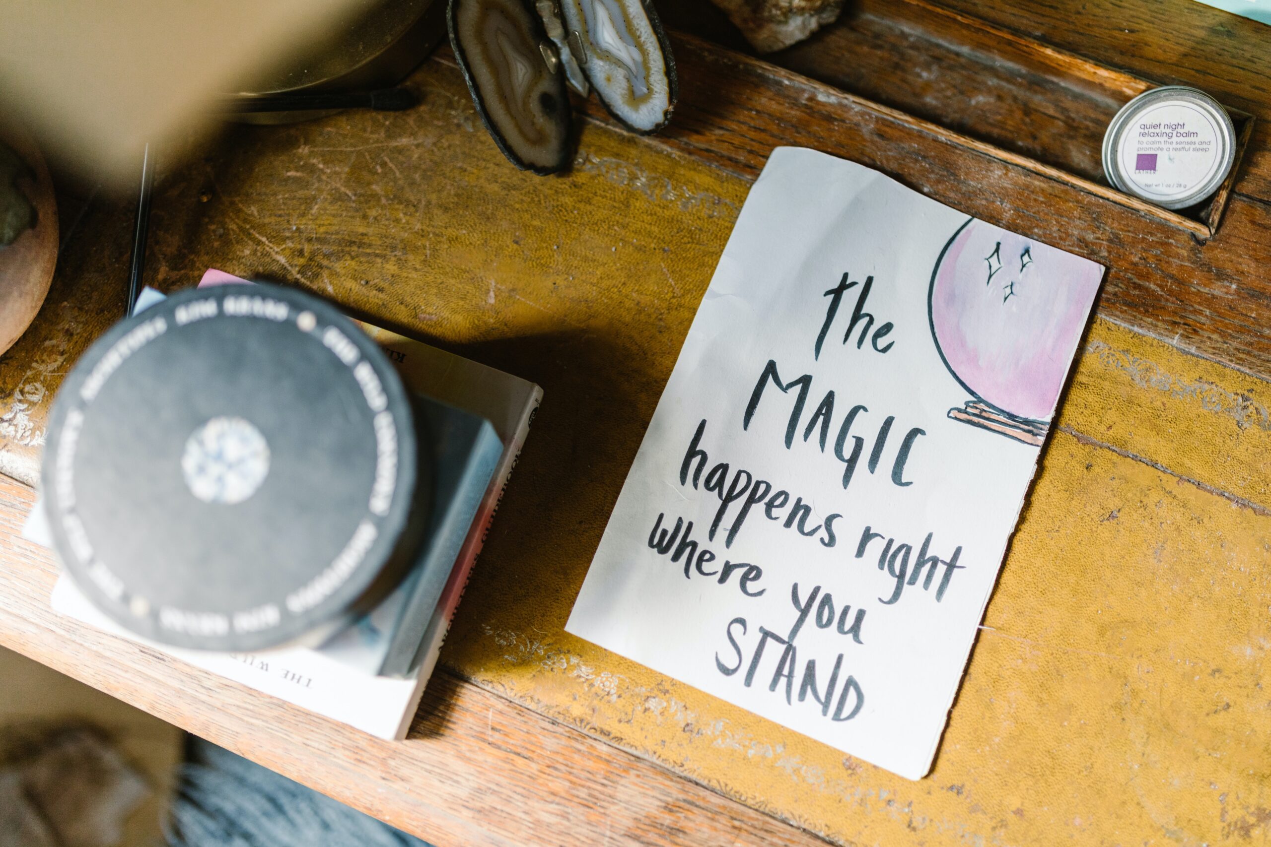 2022's energies - pad on a desk that says "the magic happens right where you stand"